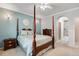 Comfortable main bedroom with en-suite bathroom featuring a four-poster bed at 15501 E 112Th Ave # 33D, Commerce City, CO 80022
