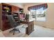 Office featuring a dark wood built in desk and cabinets, and neutral carpet at 15501 E 112Th Ave # 33D, Commerce City, CO 80022