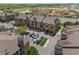 Aerial view of the building, showcasing ample parking, landscaping, proximity to the community and overall aesthetic at 15460 Canyon Gulch Ln # 105, Englewood, CO 80112