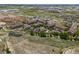 An aerial shot showcasing a residential building near a pond, walking path and natural landscaping in the neighborhood at 15460 Canyon Gulch Ln # 105, Englewood, CO 80112