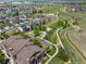Aerial view showcasing neighborhood homes, walking paths, a creek, and a playground near a residential building at 15460 Canyon Gulch Ln # 105, Englewood, CO 80112