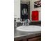 Sleek bathroom with modern sink and checker accent, enhancing the clean and functional design of the space at 15460 Canyon Gulch Ln # 105, Englewood, CO 80112