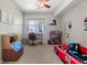 bedroom with carpet, a ceiling fan, and a red racecar bed with a playful race-themed decor at 15460 Canyon Gulch Ln # 105, Englewood, CO 80112