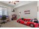 Carpeted bedroom featuring a ceiling fan, a racecar bed, and neutral walls at 15460 Canyon Gulch Ln # 105, Englewood, CO 80112