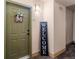 Apartment entryway featuring a green door, welcome sign and wall decor, leading into the living space at 15460 Canyon Gulch Ln # 105, Englewood, CO 80112