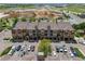 Aerial view of a multi-story apartment complex with ample parking and a construction site in the background at 15460 Canyon Gulch Ln # 105, Englewood, CO 80112