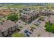 Aerial view of a residential building with a parking lot, surrounded by lush greenery, and neighborhood buildings at 15460 Canyon Gulch Ln # 105, Englewood, CO 80112