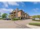 Apartment building exterior showing assigned parking, landscaping, and a view of the architecture at 15460 Canyon Gulch Ln # 105, Englewood, CO 80112