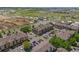 Aerial view of a residential building surrounded by parking area and commercial property with construction in view at 15460 Canyon Gulch Ln # 105, Englewood, CO 80112