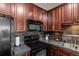 This kitchen boasts stainless steel appliances and stylish dark cabinets at 15460 Canyon Gulch Ln # 105, Englewood, CO 80112