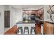 Kitchen with dark cabinetry, granite countertops and stainless steel appliances with island and seating at 15460 Canyon Gulch Ln # 105, Englewood, CO 80112