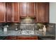 This kitchen boasts stainless steel sink, beautiful granite countertops, and stylish dark cabinets at 15460 Canyon Gulch Ln # 105, Englewood, CO 80112