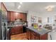 Kitchen with granite countertops, dark wood cabinets, and a central island overlooking the living area at 15460 Canyon Gulch Ln # 105, Englewood, CO 80112
