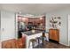 Kitchen featuring an island with seating, stainless steel appliances and dark wood cabinets at 15460 Canyon Gulch Ln # 105, Englewood, CO 80112