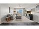 Bright living room features an comfortable gray couch and entertainment center at 15460 Canyon Gulch Ln # 105, Englewood, CO 80112