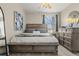 Bright main bedroom with large window, comfortable bed, dresser and a ceiling fan at 15460 Canyon Gulch Ln # 105, Englewood, CO 80112