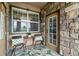 Charming porch featuring stone accents, outdoor seating, and a welcoming entryway, enhancing the home's curb appeal at 15460 Canyon Gulch Ln # 105, Englewood, CO 80112