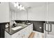 Bright, charming bathroom featuring dual sinks, stone counters, and new fixtures at 2862 W Long Dr # A, Littleton, CO 80120