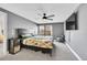 Comfortable bedroom featuring a ceiling fan, television, and plush carpeting at 2862 W Long Dr # A, Littleton, CO 80120