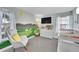 Charming Bedroom with a rocking chair, crib, and colorful mural at 2862 W Long Dr # A, Littleton, CO 80120