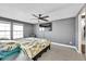 Bright bedroom featuring gray walls, plush carpet, a ceiling fan, and TV at 2862 W Long Dr # A, Littleton, CO 80120