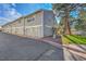 Exterior of a townhouse with a garage and well-maintained landscaping at 2862 W Long Dr # A, Littleton, CO 80120
