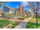 Exterior view of townhomes with well-maintained landscaping, showcasing a serene community setting at 2862 W Long Dr # A, Littleton, CO 80120