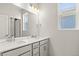 Bathroom featuring double sink vanity and bright lighting at 2662 E 103Rd Ave, Thornton, CO 80229