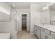 Ensuite bathroom featuring double sinks, a walk-in shower, and a walk-in closet at 2662 E 103Rd Ave, Thornton, CO 80229