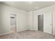 A carpeted bedroom featuring an ensuite bath and walk-in closet at 2662 E 103Rd Ave, Thornton, CO 80229