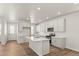 Bright kitchen featuring white cabinets, island with sink, and stainless steel appliances at 2662 E 103Rd Ave, Thornton, CO 80229