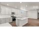 Modern kitchen featuring white cabinets, stainless steel appliances, and hardwood floors at 2662 E 103Rd Ave, Thornton, CO 80229