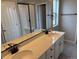 Bathroom featuring a double sink vanity with a quartz countertop and a glass shower enclosure at 1759 Jennifer St, Brighton, CO 80601