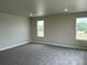 Spacious bedroom featuring plush carpet and bright natural light from two well-placed windows at 1759 Jennifer St, Brighton, CO 80601