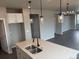 Kitchen island with sink and stainless steel appliances for easy clean up at 1759 Jennifer St, Brighton, CO 80601