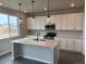 Modern kitchen featuring white cabinets, an island, and stainless steel appliances at 1759 Jennifer St, Brighton, CO 80601