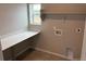 Functional laundry room with folding counter, window, and convenient hookups at 1759 Jennifer St, Brighton, CO 80601