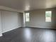 Spacious living room with wood-look flooring and ample natural light at 1759 Jennifer St, Brighton, CO 80601
