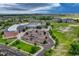 An aerial view captures the school with expansive grounds, parking and athletic fields at 5255 Memphis St # 1009, Denver, CO 80239