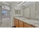 Bathroom features a double sink vanity with wood cabinets and granite countertops at 5255 Memphis St # 1009, Denver, CO 80239