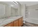 Bathroom featuring double sinks, granite countertops, and a shower-tub combination at 5255 Memphis St # 1009, Denver, CO 80239