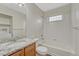 Bright bathroom features modern vanity, granite countertop, and shower/tub combo at 5255 Memphis St # 1009, Denver, CO 80239