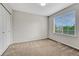 Neutral bedroom with a large window and spacious closet for storage at 5255 Memphis St # 1009, Denver, CO 80239