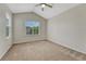 Bright bedroom featuring vaulted ceiling, large window, and neutral carpet at 5255 Memphis St # 1009, Denver, CO 80239