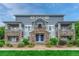 Charming townhome with stone facade and double blue doors creates an inviting entryway at 5255 Memphis St # 1009, Denver, CO 80239