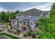 Beautiful multi-story condo with stone accents, blue siding, and a charming front entrance and lush landscaping at 5255 Memphis St # 1009, Denver, CO 80239