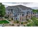 Blue townhome exterior with stone accents, well-kept landscaping, and inviting balconies at 5255 Memphis St # 1009, Denver, CO 80239