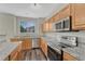 Bright updated kitchen with stainless appliances, granite countertops and light wood cabinets at 5255 Memphis St # 1009, Denver, CO 80239