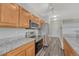 Modern kitchen boasts stainless appliances, granite countertops, wood cabinets, and sleek flooring at 5255 Memphis St # 1009, Denver, CO 80239