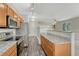 Open kitchen features stainless appliances, granite countertops, light wood cabinets and wood floors at 5255 Memphis St # 1009, Denver, CO 80239